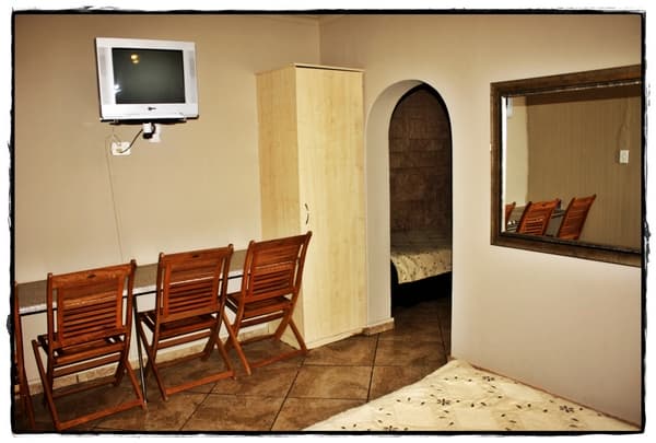 Guest room interior with seating and wardrobe