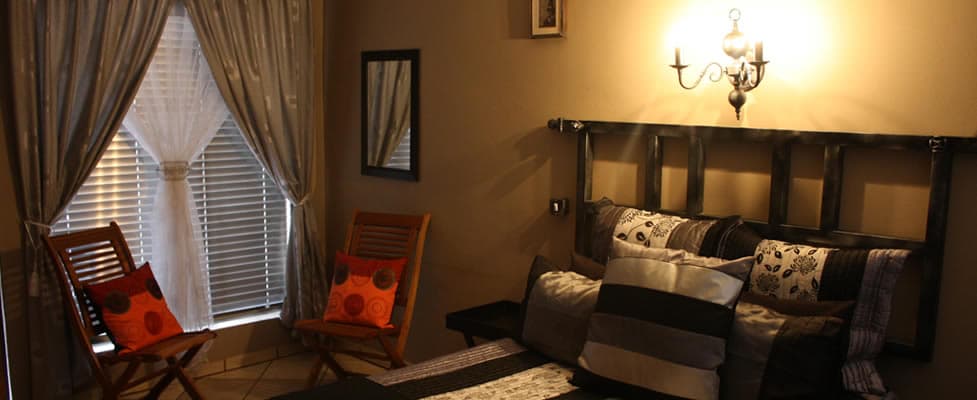 Warm and comfortable guest room at Safari Travelodge